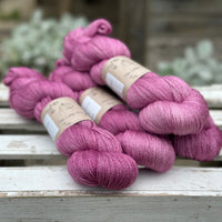 Four skeins of light purpley-pink yarn