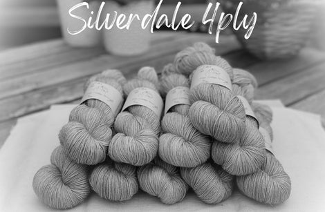 A black and white image of ten skeins of yarn with spakly filament visible around the skeins. "Silverdale 4ply" is in white text at the top of the image