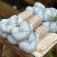 the same five skeins viewed from an angle which shows how lustrous the yarn is