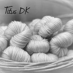 Black and white image of skeins of yarn with "Titus DK" overlaid in black text